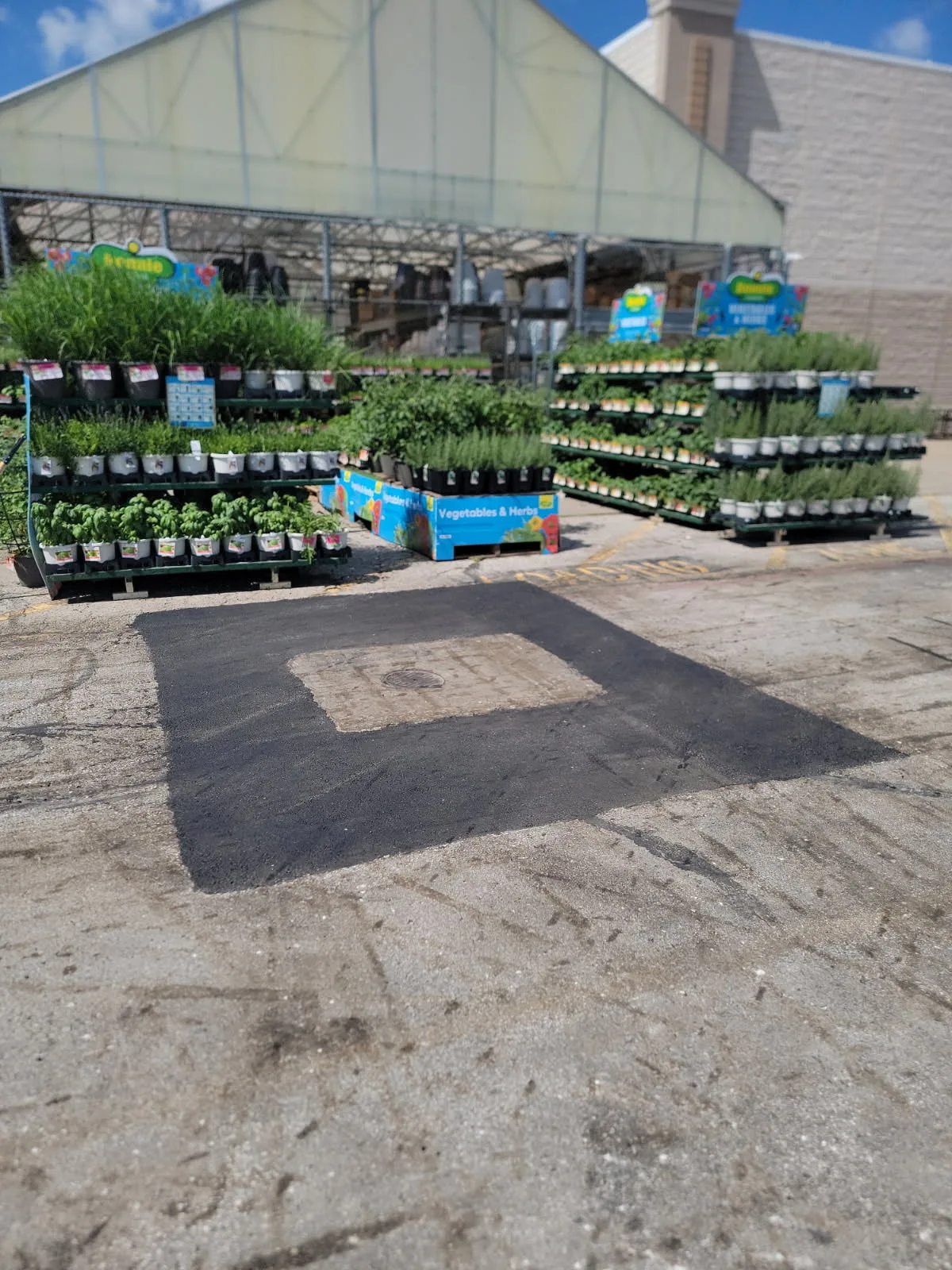 Permanent pothole repair on a Kansas City commercial lot — clean rectangular hot-mix patch